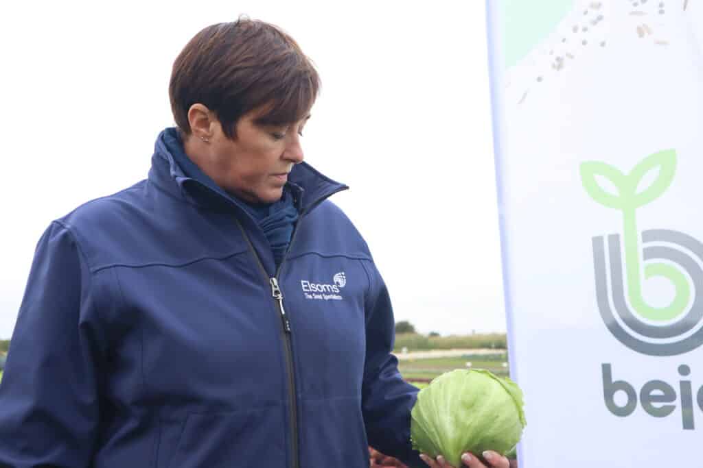 Lisa Tokelove stood with some Bejo Lettuce in a field